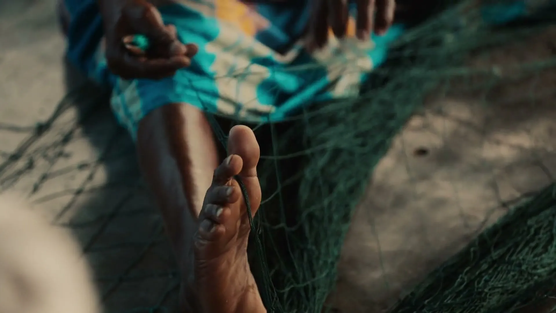 A foot among the nets while the hands work