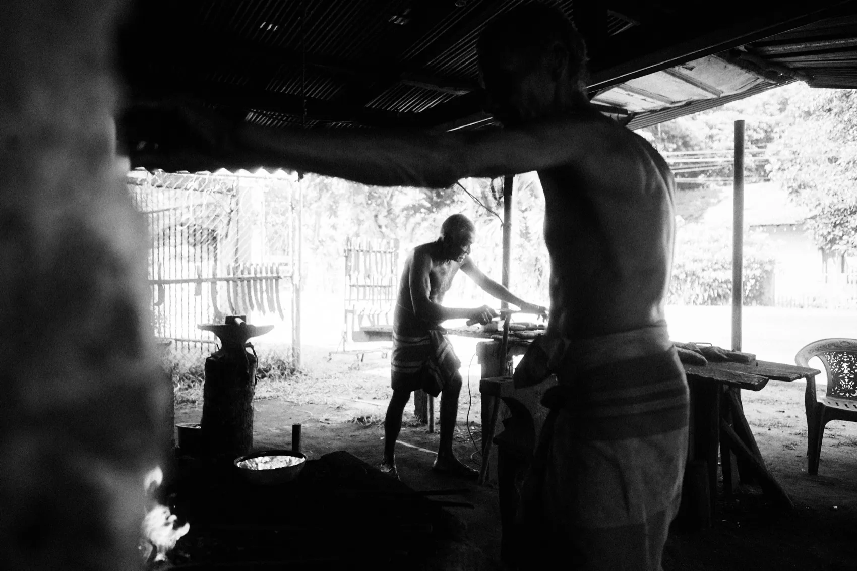 A blacksmith's feet and a hammer on the ground