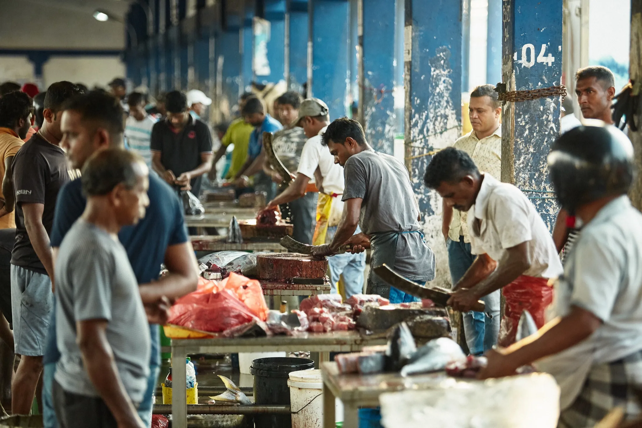 The row of cutting tables under the market roof