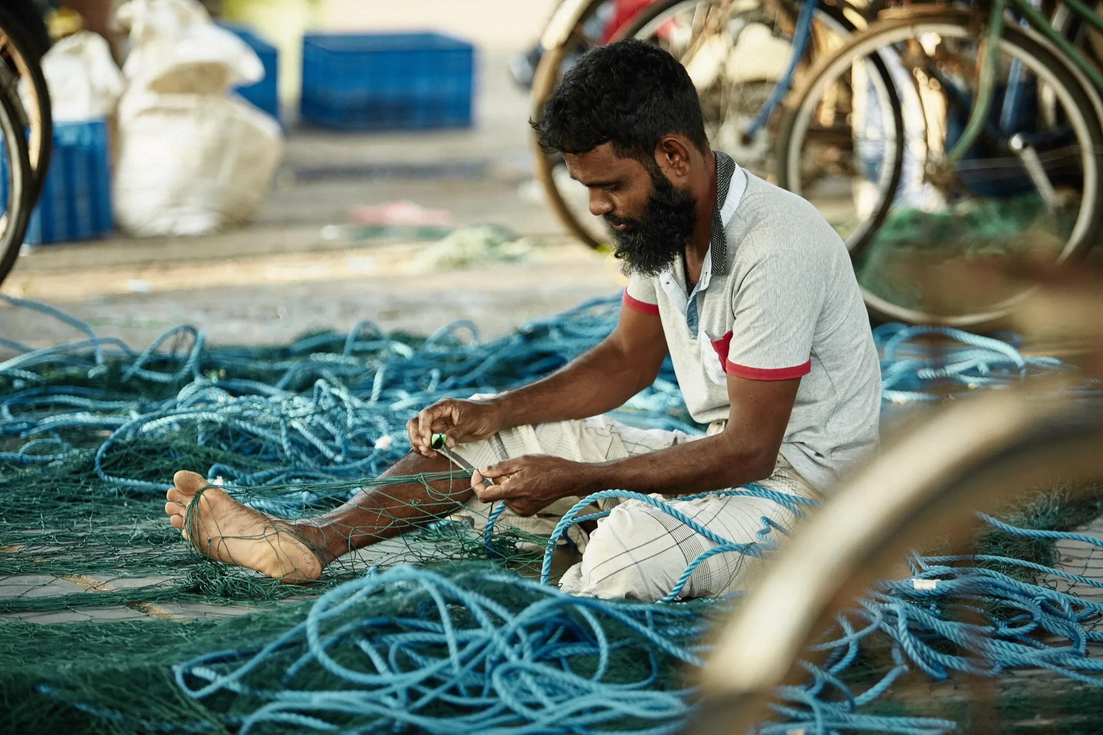 A man working over blue netting