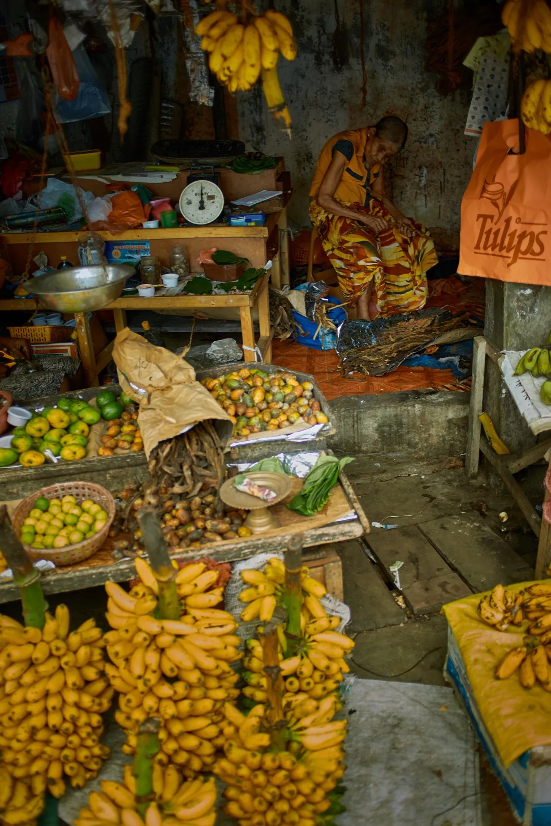 A seller under a price board