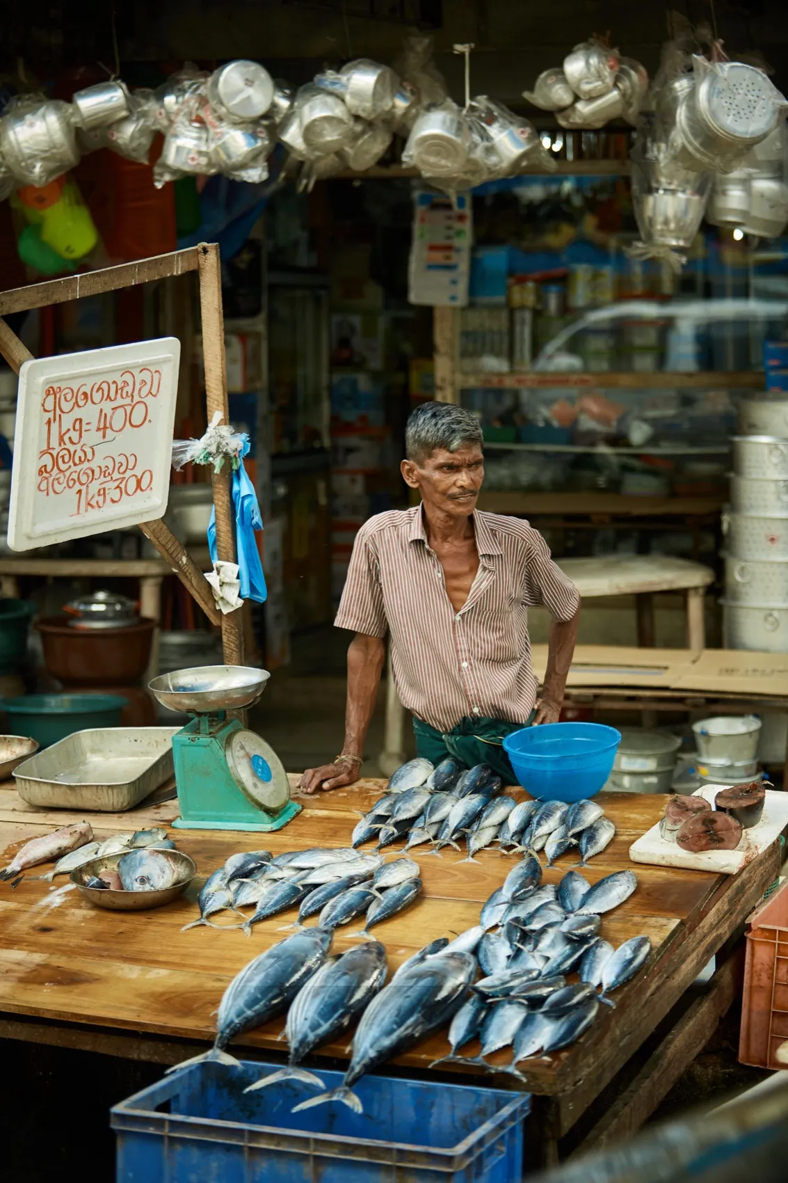 A fish seller sitting by his scale